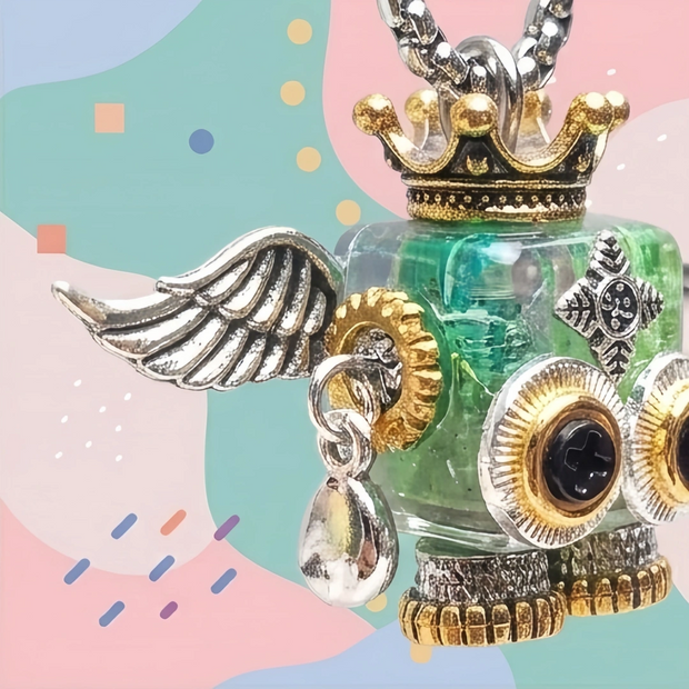 Mint green steampunk winged robot necklace with a gold crown.