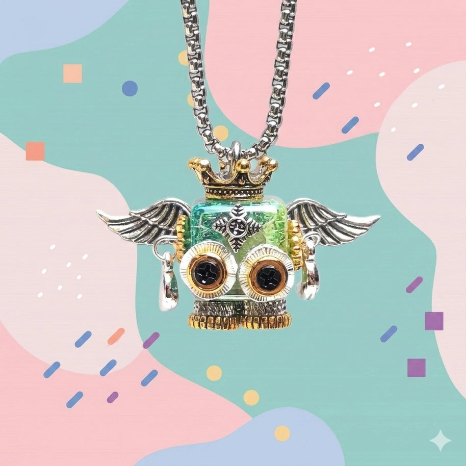 Close-up of a steampunk-style robot pendant necklace. The robot has a square, shiny mint-green body, gear-shaped eyes, metallic silver angel wings, and a small golden crown on its head, hanging on a silver chain.