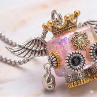 A quirky blend of steampunk gears, metal wings, and an iridescent pink core. A perfectly unique gift!