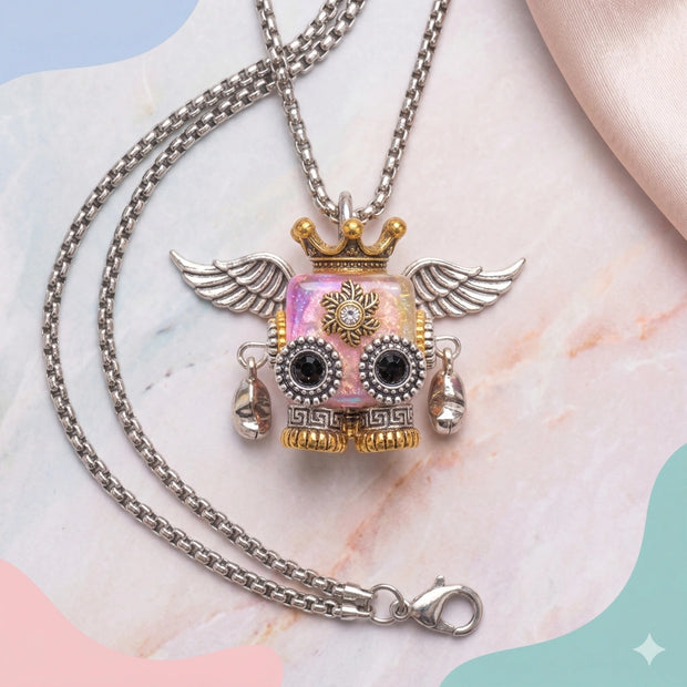 A cute pink steampunk robot pendant with silver wings and a gold crown.