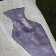 Close-up of The purple Blossom Tote, integrated pocket holding a fresh pink flower.