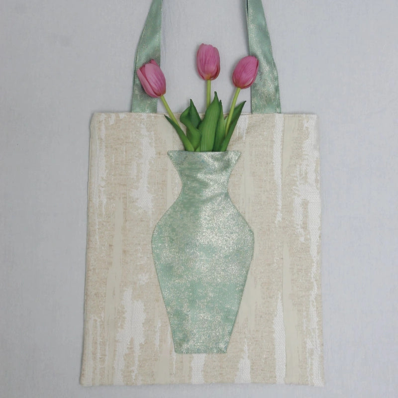 Close-up of the embroidered vase pocket on The Green Blossom Tote with real flowers inside.
