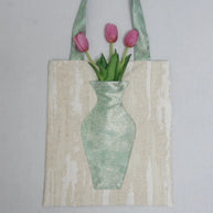 Close-up of the embroidered vase pocket on The Green Blossom Tote with real flowers inside.