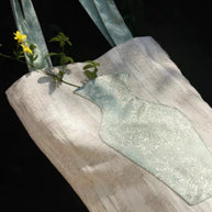 Close-up of the embroidered vase pocket on The Green Blossom Tote with real flowers inside.