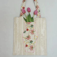 Close-up of the embroidered vase pocket on The Pink Blossom Tote with real flowers inside.
